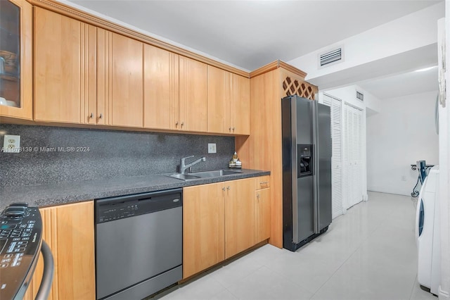 kitchen featuring light brown cabinetry, sink, decorative backsplash, and stainless steel appliances