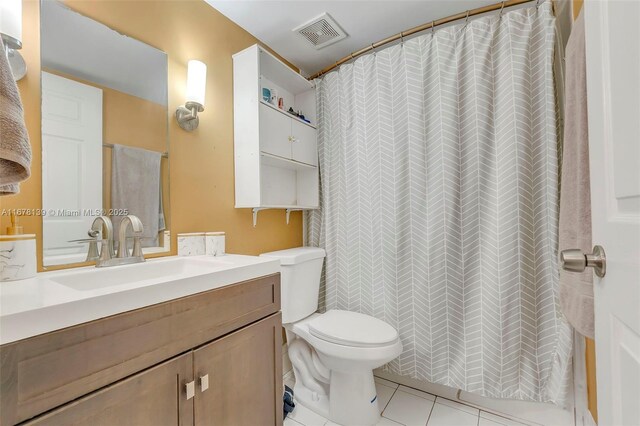 bathroom featuring vanity, curtained shower, toilet, and tile patterned floors