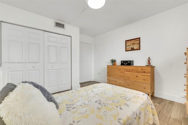 bedroom featuring wood-type flooring and a closet