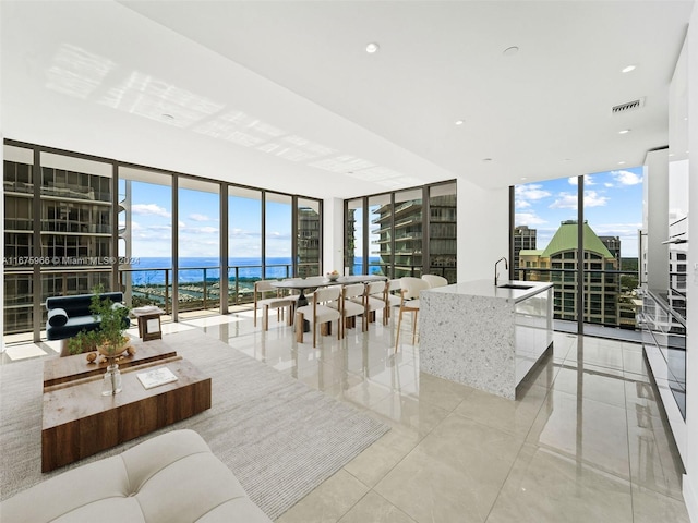 living room with a water view and floor to ceiling windows