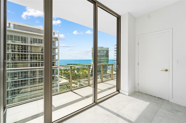 doorway to outside featuring a water view and tile patterned floors