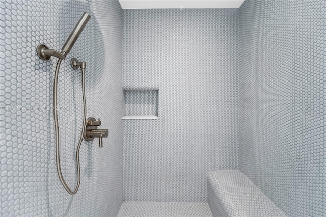 bathroom with tiled shower