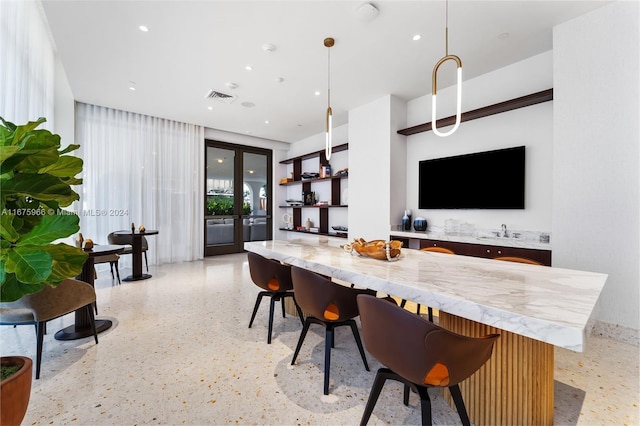 interior space with recessed lighting, light speckled floor, visible vents, and decorative light fixtures