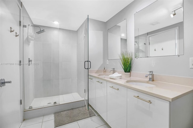 bathroom with vanity, tile patterned flooring, and walk in shower