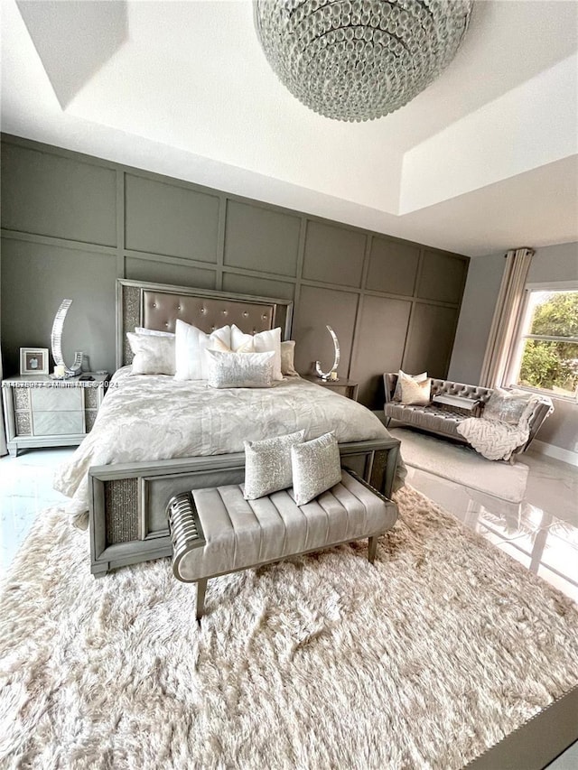 tiled bedroom featuring a tray ceiling