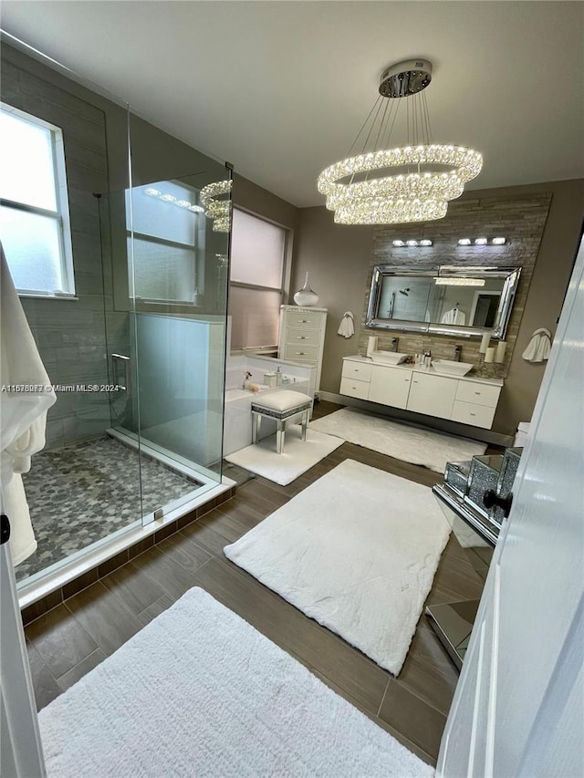 bathroom with vanity, a notable chandelier, hardwood / wood-style flooring, and an enclosed shower