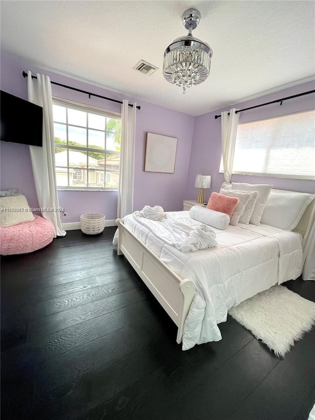 bedroom with dark hardwood / wood-style flooring