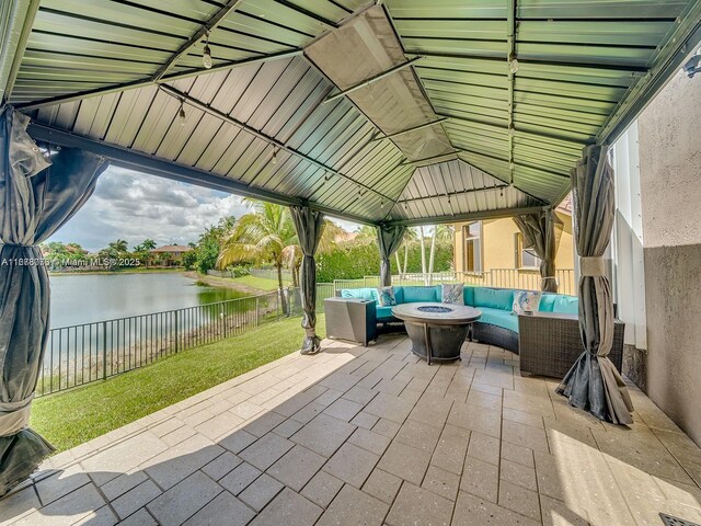 view of tennis court with a water view