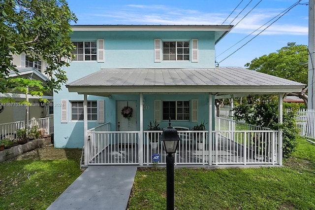 view of front of property with covered porch and a front yard