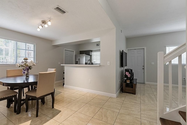 dining area featuring light tile patterned floors