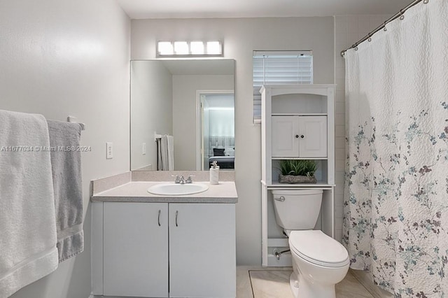 bathroom with vanity, toilet, and tile patterned flooring