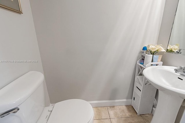 bathroom with toilet and tile patterned floors