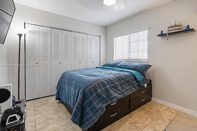 tiled bedroom with a closet and ceiling fan