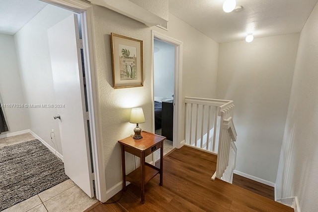 hall with hardwood / wood-style floors