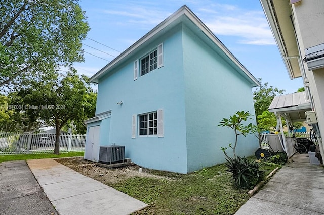 view of side of home with central air condition unit