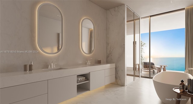 bathroom featuring vanity, a bathtub, floor to ceiling windows, and a water view