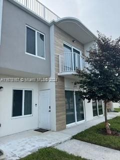 rear view of house featuring a balcony