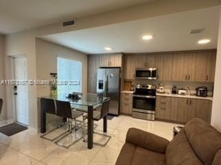 kitchen featuring appliances with stainless steel finishes and light tile patterned floors