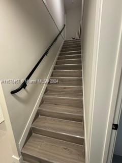 stairs with hardwood / wood-style floors