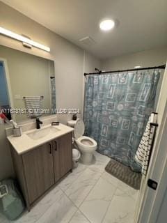 bathroom featuring vanity, toilet, and curtained shower