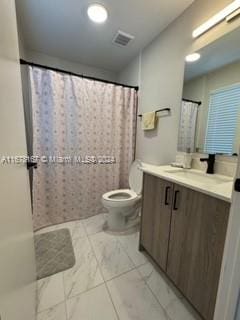 bathroom featuring vanity, a shower with curtain, and toilet