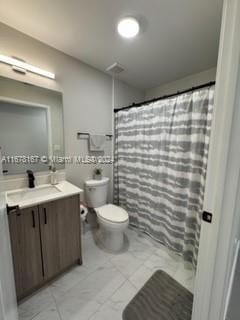 bathroom with vanity, toilet, and curtained shower