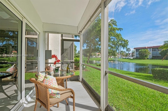 sunroom / solarium with a water view