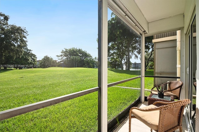 sunroom / solarium with a water view