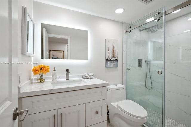 bathroom with vanity, toilet, and an enclosed shower