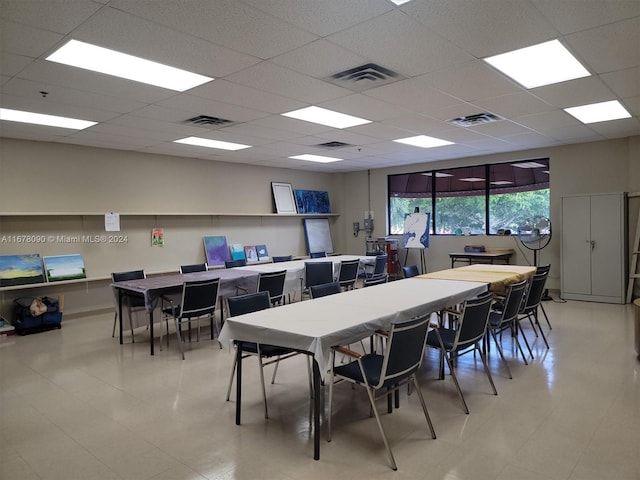 dining space featuring a drop ceiling