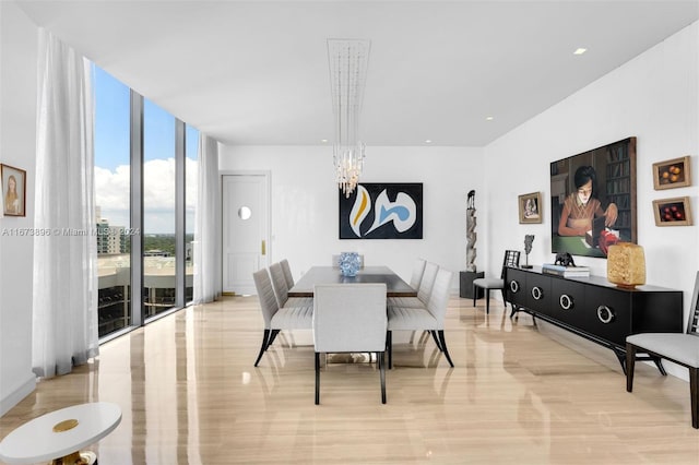 dining area featuring expansive windows and a notable chandelier