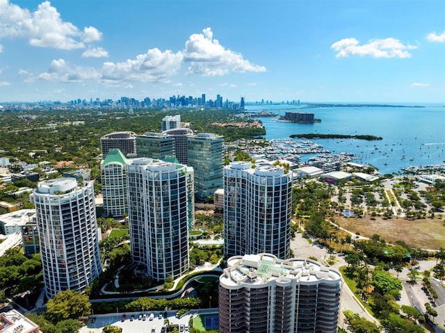 birds eye view of property with a water view and a city view