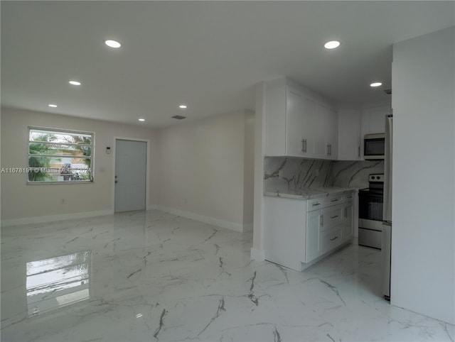 kitchen featuring white cabinets, electric range, tasteful backsplash, and light stone counters