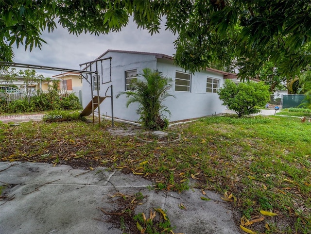 view of side of property with a yard