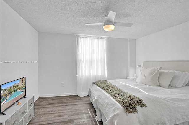 bedroom featuring hardwood / wood-style floors, a textured ceiling, and ceiling fan