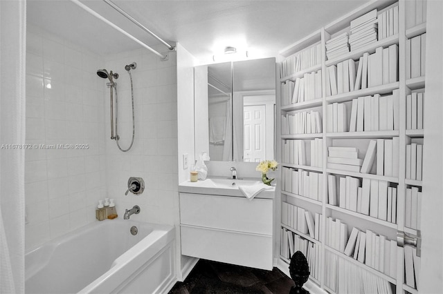 bathroom featuring vanity and tiled shower / bath