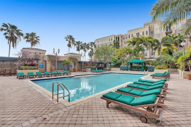 view of swimming pool with a gazebo and a patio