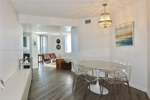 dining area featuring dark hardwood / wood-style floors and a notable chandelier