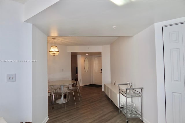 corridor with dark hardwood / wood-style flooring