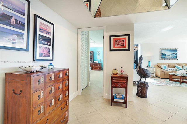 hall featuring light tile patterned flooring