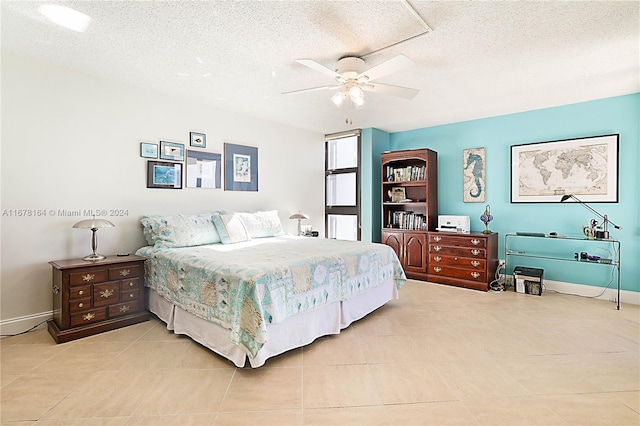 bedroom featuring a textured ceiling, light tile patterned floors, and ceiling fan