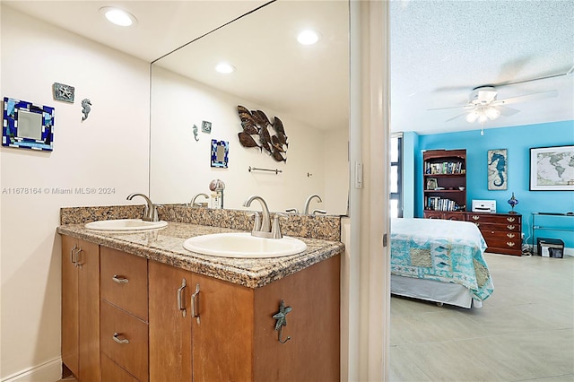 5550 N Ocean Dr Unit 8B, Singer Island, FL 33404 - ensuite bathroom with double vanity and a ceiling fan