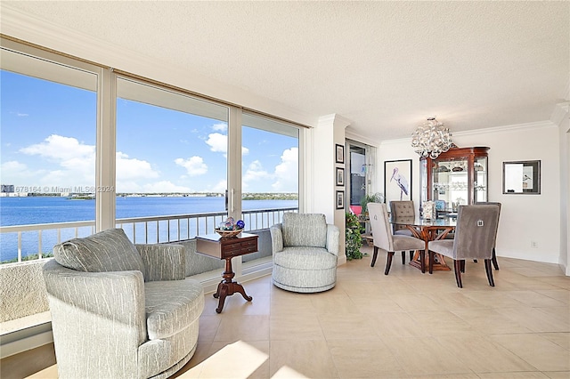 sunroom featuring a water view and an inviting chandelier