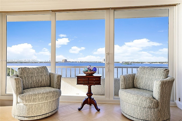 interior space with a water view and tile patterned floors