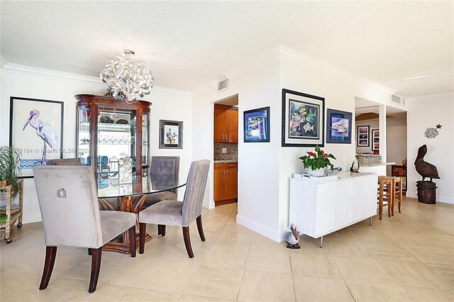 5550 N Ocean Dr Unit 8B, Singer Island, FL 33404 - dining space featuring ornamental molding, a chandelier, a textured ceiling, and light tile patterned flooring