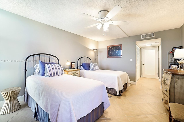 5550 N Ocean Dr Unit 8B, Singer Island, FL 33404 - bedroom with ceiling fan, a textured ceiling, and light tile patterned floors
