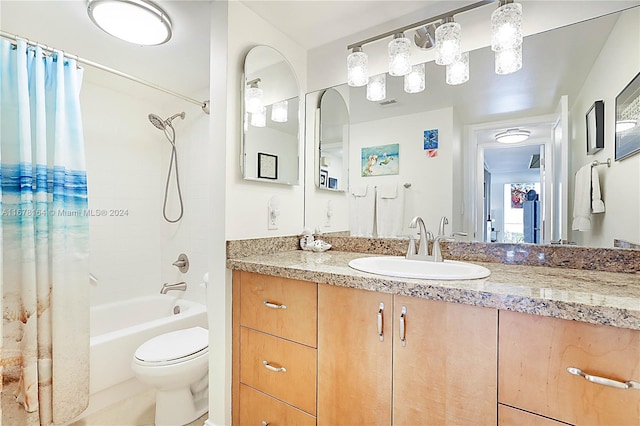 full bathroom with toilet, vanity, and shower / bath combo with shower curtain