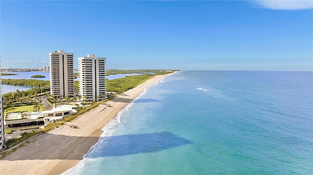 bird's eye view with a water view and a beach view