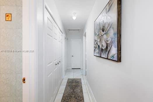 hall featuring light tile patterned flooring