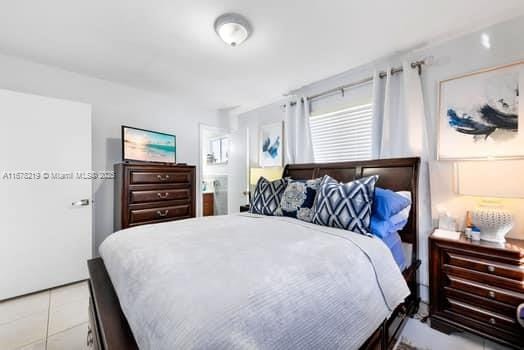 bedroom with light tile patterned floors